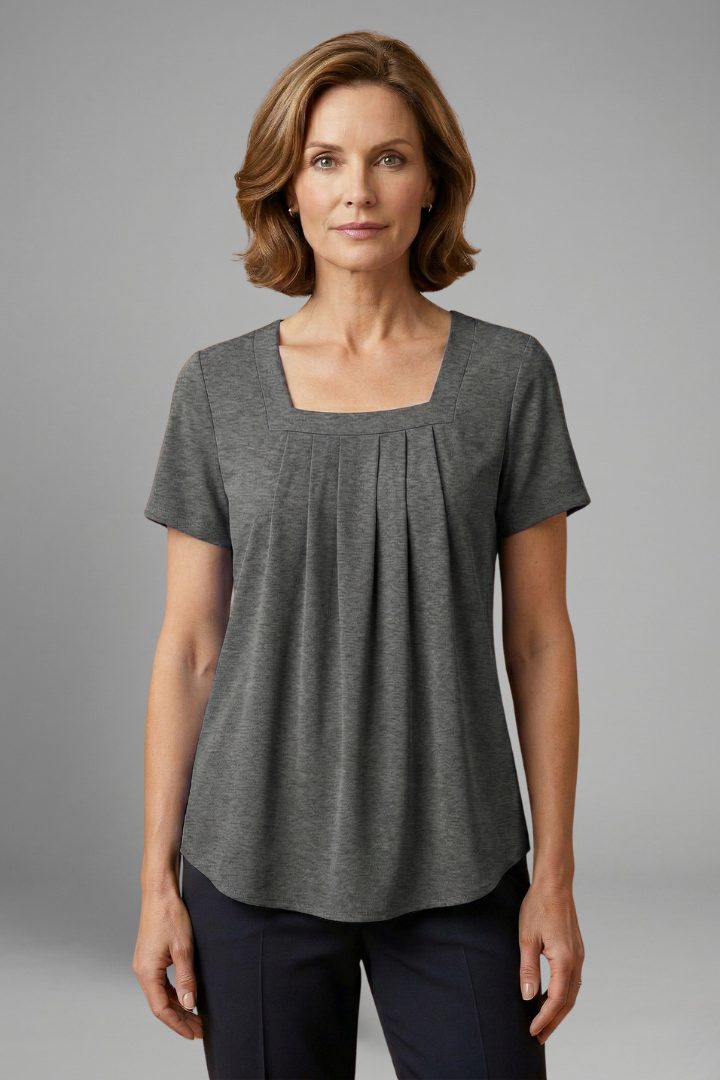 Women’s tunic top with square neckline, pleated front detail, loose fit, and hip-length hem for casual everyday styling.
