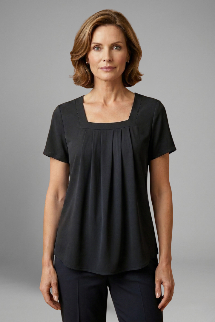 Women’s tunic top with square neckline, pleated front detail, loose fit, and hip-length hem for casual everyday styling.
