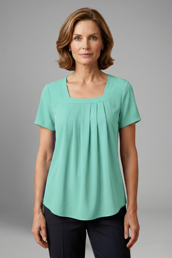 Women’s tunic top with square neckline, pleated front detail, loose fit, and hip-length hem for casual everyday styling.