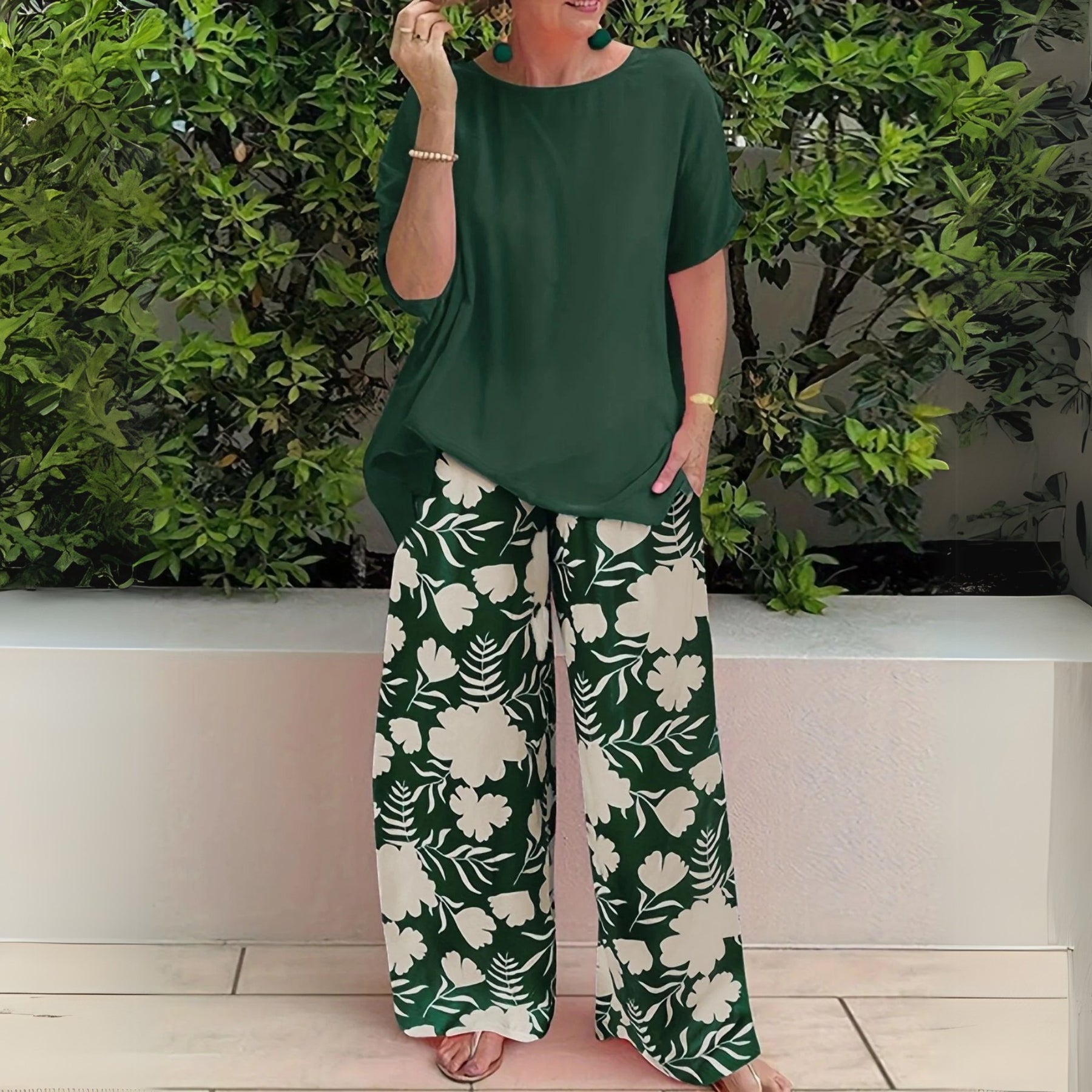 Women’s two-piece set featuring a relaxed-fit top and floral wide-leg pants, suitable for casual outings, travel, and everyday wear.