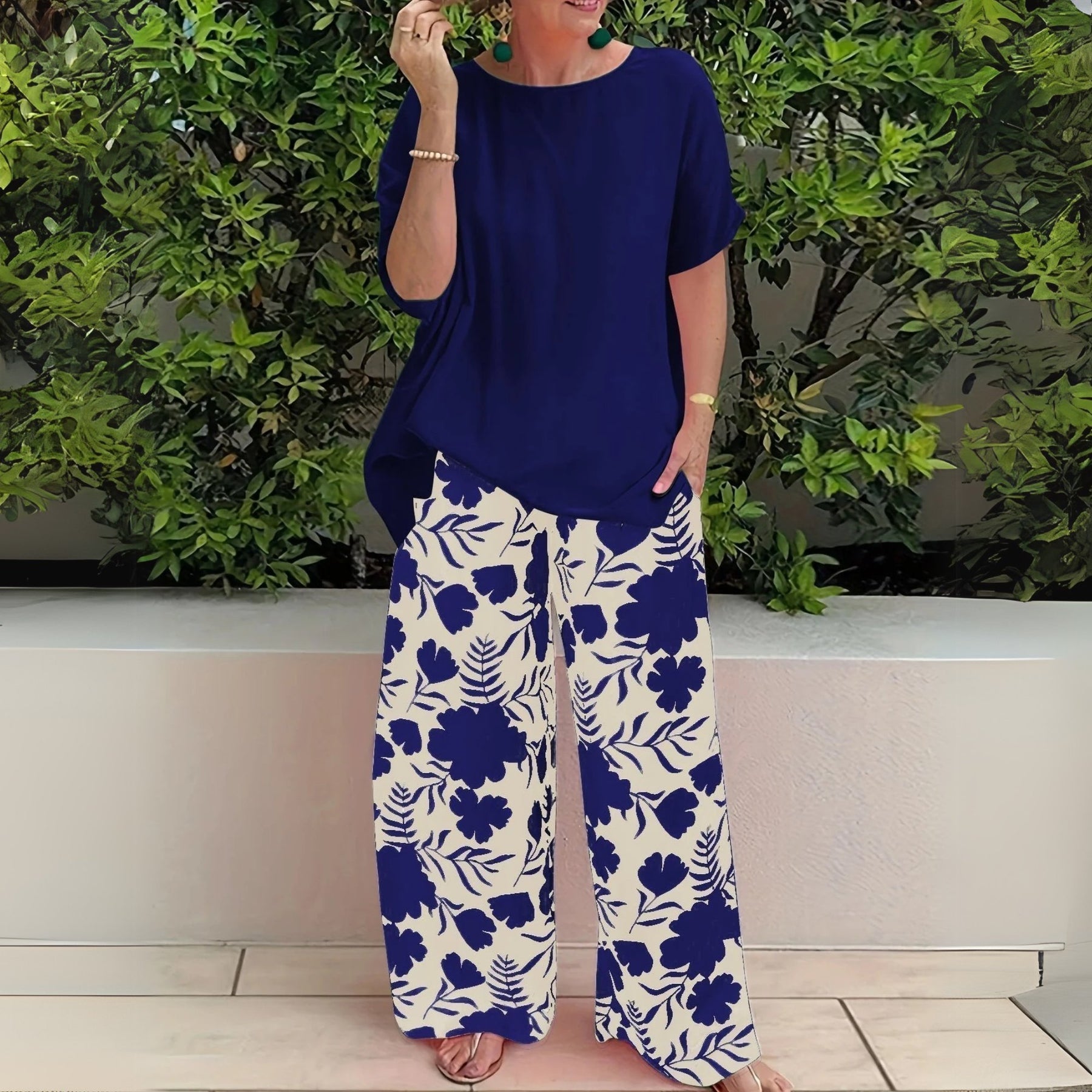 Women’s two-piece set featuring a relaxed-fit top and floral wide-leg pants, suitable for casual outings, travel, and everyday wear.