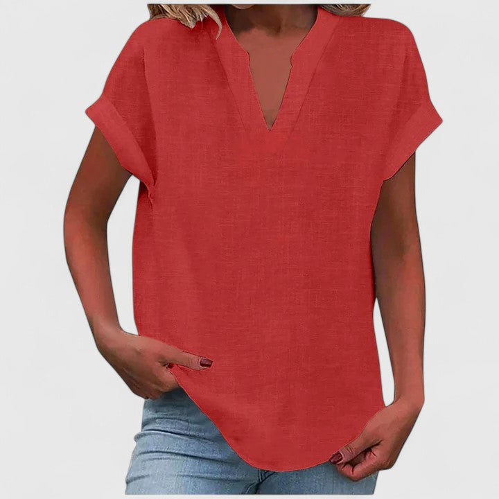 Women’s V-neck blouse with rolled short sleeves and relaxed fit, ideal for smart-casual outfits and everyday styling.