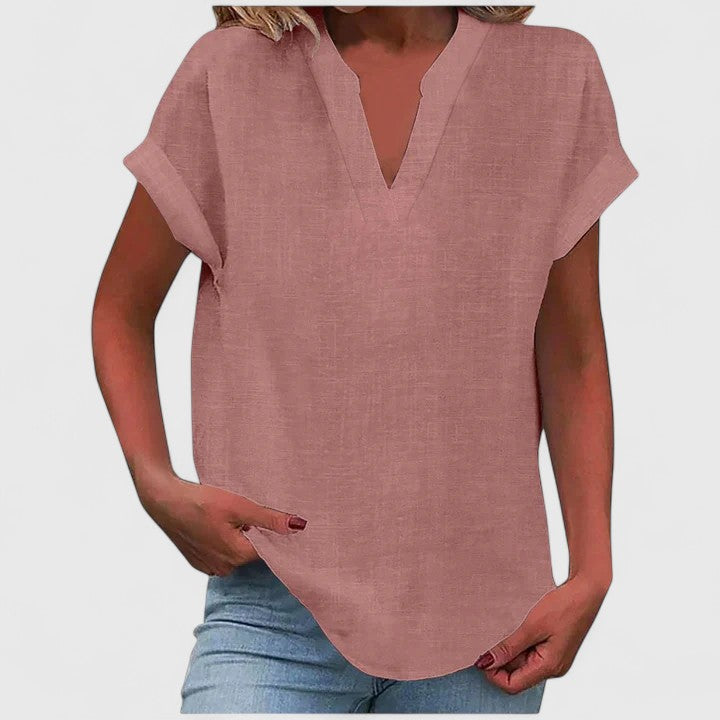 Women’s V-neck blouse with rolled short sleeves and relaxed fit, ideal for smart-casual outfits and everyday styling.