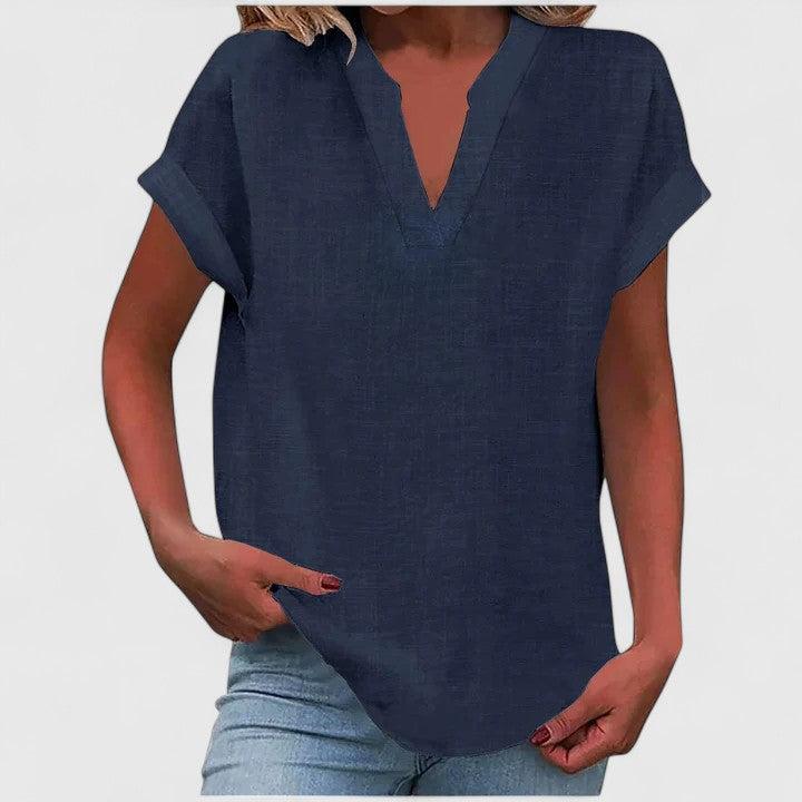 Women’s V-neck blouse with rolled short sleeves and relaxed fit, ideal for smart-casual outfits and everyday styling.