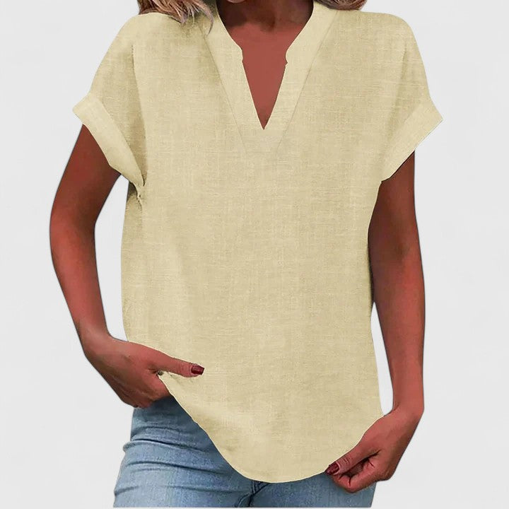 Women’s V-neck blouse with rolled short sleeves and relaxed fit, ideal for smart-casual outfits and everyday styling.