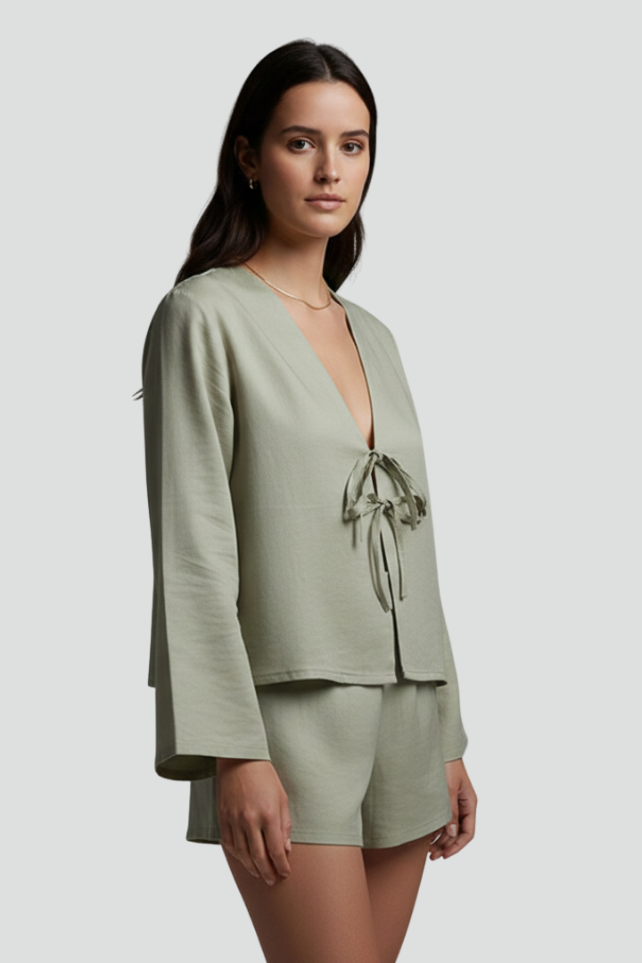 Women’s blouse with deep V-neckline and lace-up tie closure, featuring long sleeves and a relaxed fit for everyday and casual wear