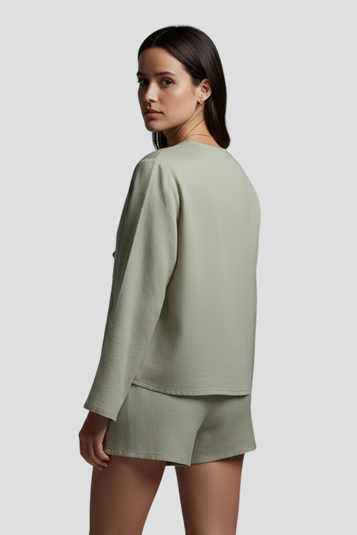 Women’s blouse with deep V-neckline and lace-up tie closure, featuring long sleeves and a relaxed fit for everyday and casual wear