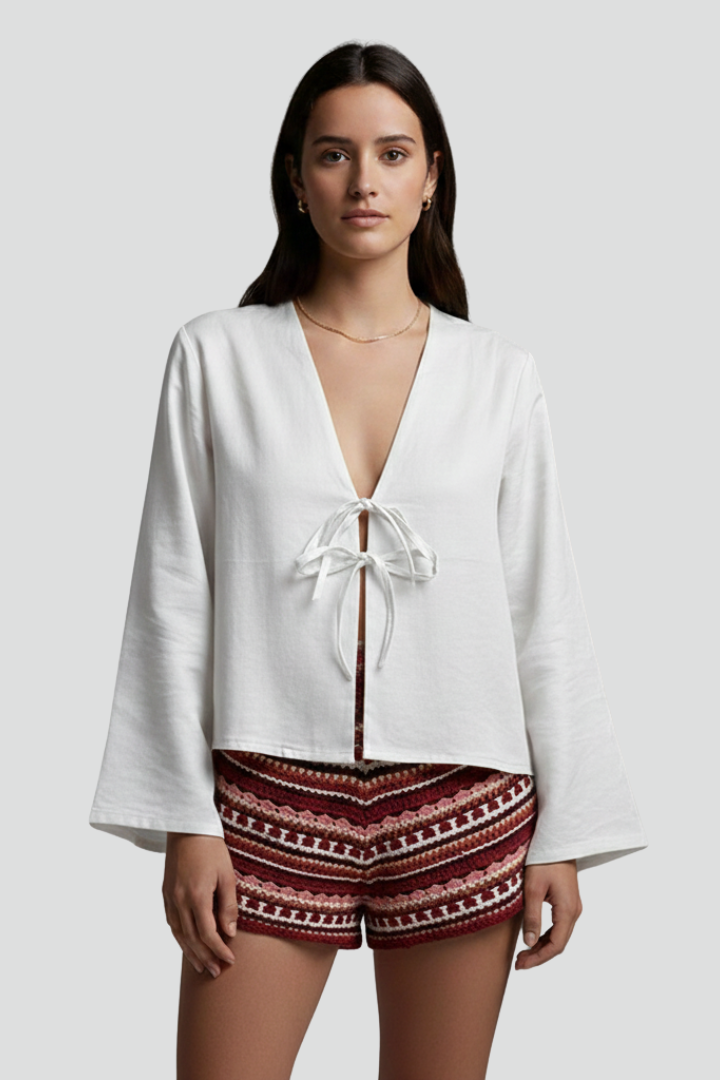 Women’s blouse with deep V-neckline and lace-up tie closure, featuring long sleeves and a relaxed fit for everyday and casual wear