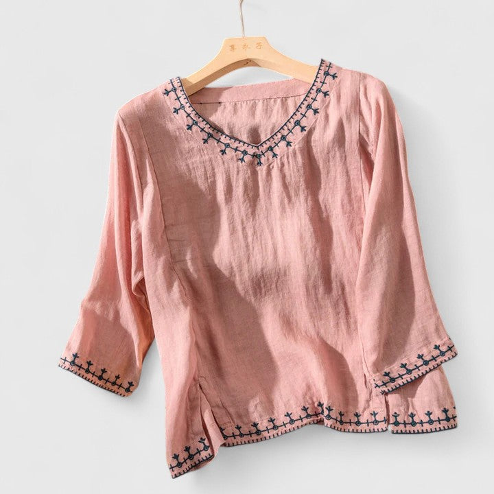 Women’s v-neck blouse with embroidered detailing and a relaxed fit, suitable for office outfits, casual wear, and smart occasions.