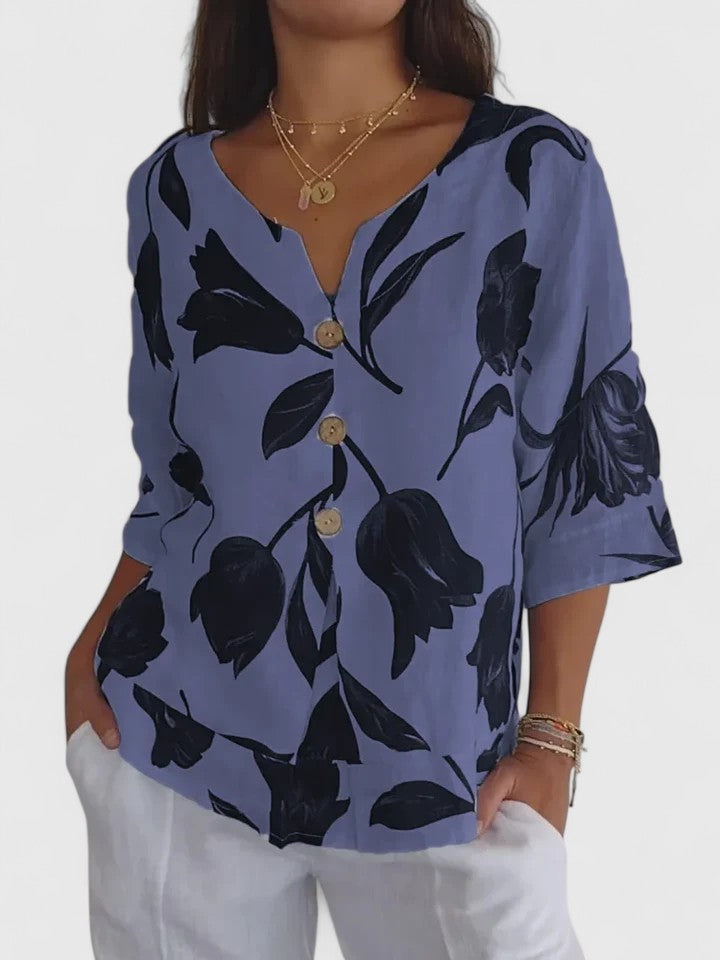 Women’s v-neck blouse with a floral print and relaxed fit, suitable for casual outfits, office wear, and evening occasions.