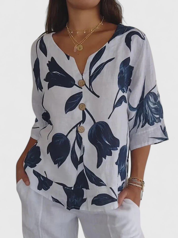 Women’s v-neck blouse with a floral print and relaxed fit, suitable for casual outfits, office wear, and evening occasions.