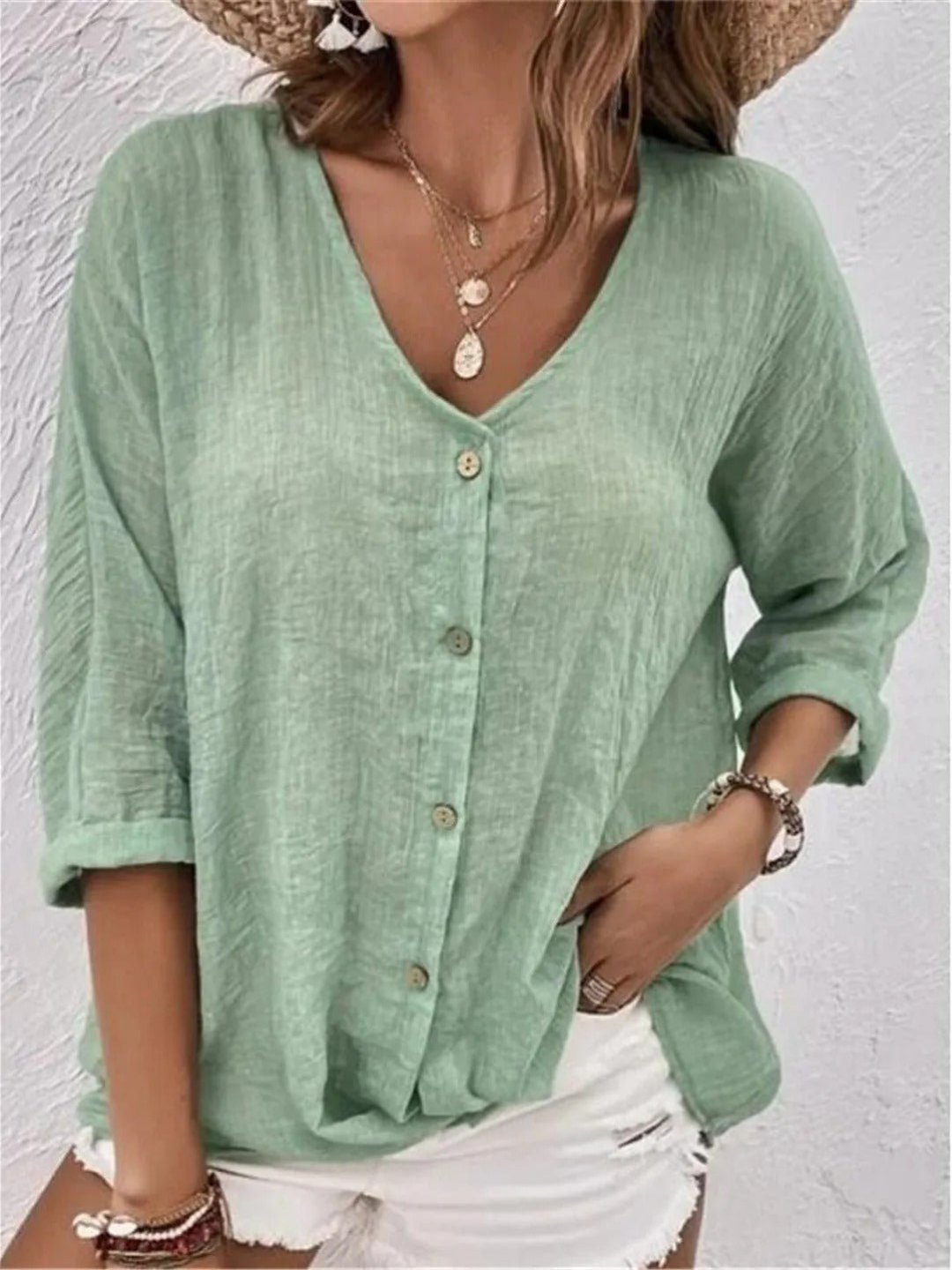 Women’s V-neck top with button-front closure and three-quarter sleeves, perfect for casual wear, travel, and warm-weather styling.
