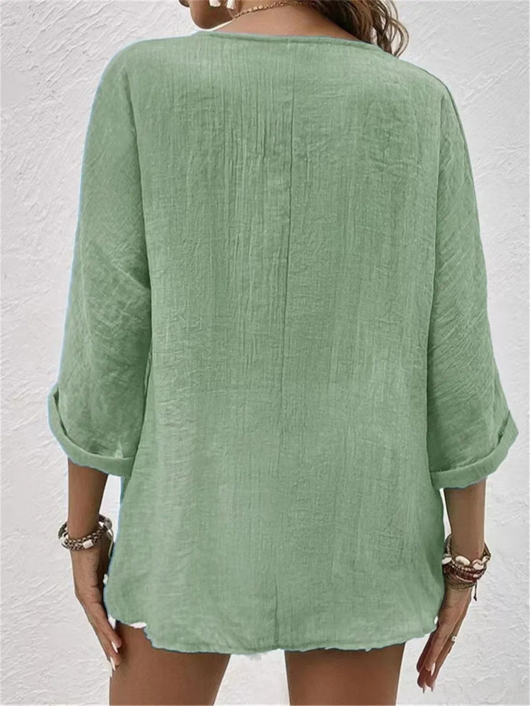 Women’s V-neck top with button-front closure and three-quarter sleeves, perfect for casual wear, travel, and warm-weather styling.