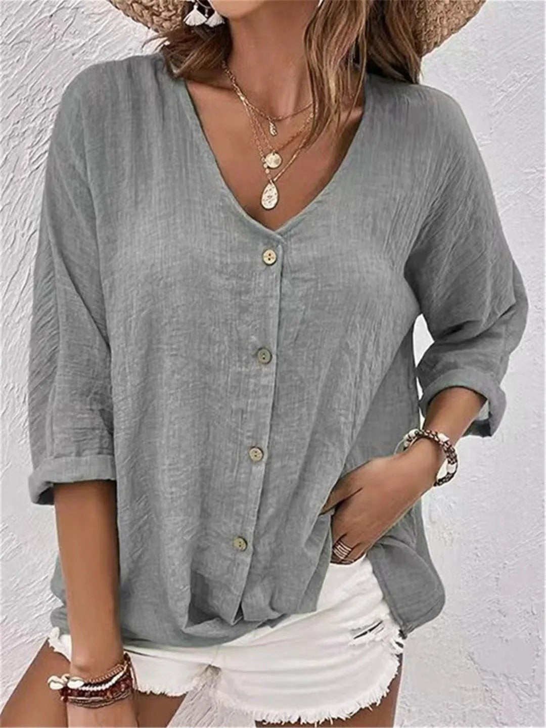 Women’s V-neck top with button-front closure and three-quarter sleeves, perfect for casual wear, travel, and warm-weather styling.