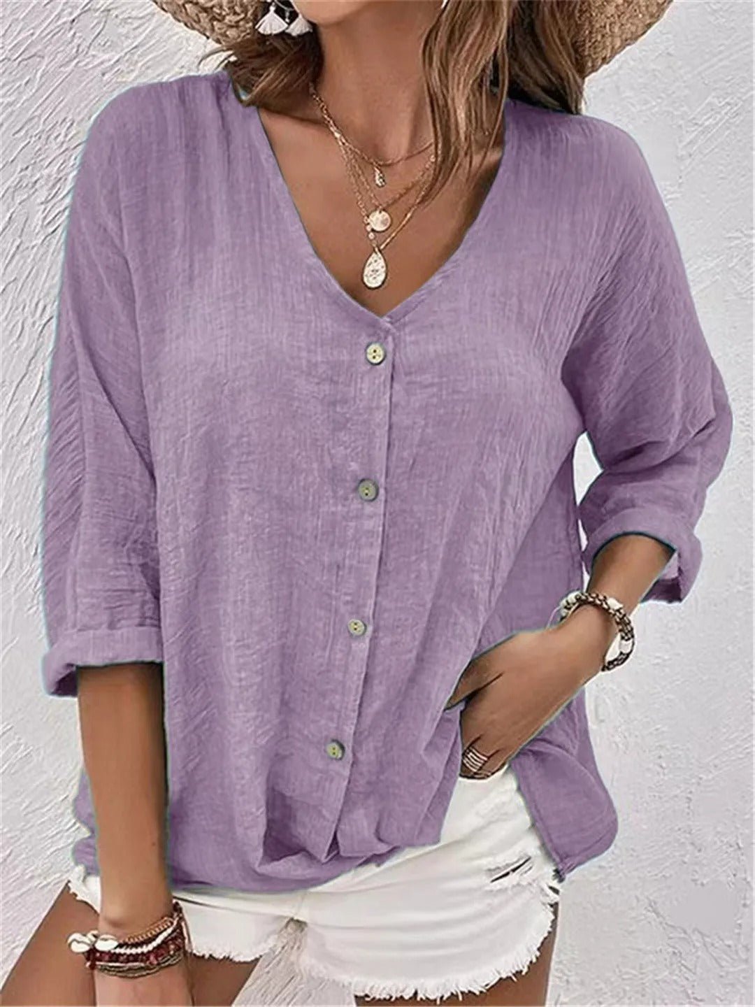Women’s V-neck top with button-front closure and three-quarter sleeves, perfect for casual wear, travel, and warm-weather styling.