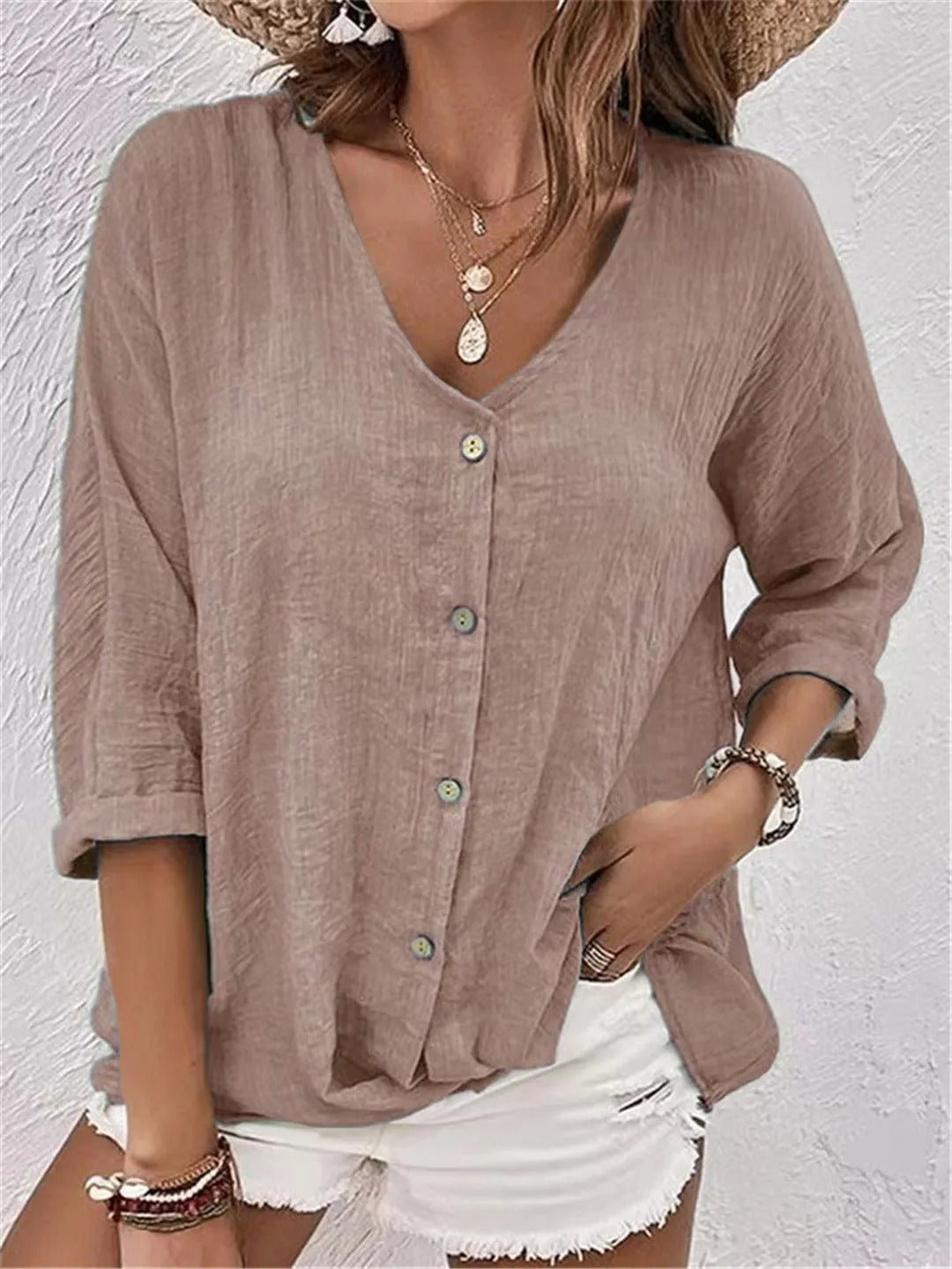 Women’s V-neck top with button-front closure and three-quarter sleeves, perfect for casual wear, travel, and warm-weather styling.