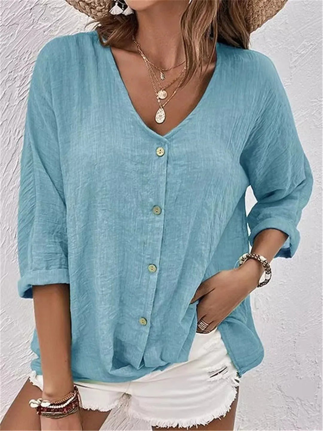 Women’s V-neck top with button-front closure and three-quarter sleeves, perfect for casual wear, travel, and warm-weather styling.