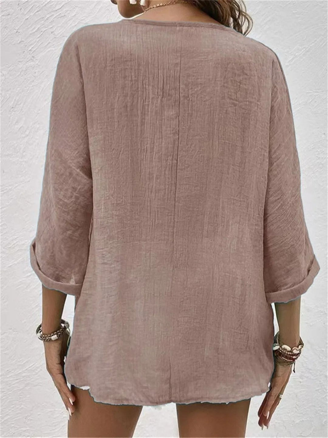 Women’s V-neck top with button-front closure and three-quarter sleeves, perfect for casual wear, travel, and warm-weather styling.