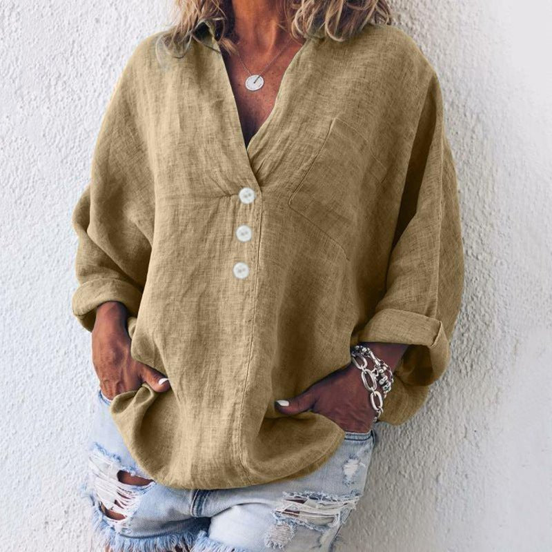 Women’s blouse with V-neckline, roll-tab sleeves, button-front closure, and relaxed oversized fit, suitable for office wear and everyday styling.